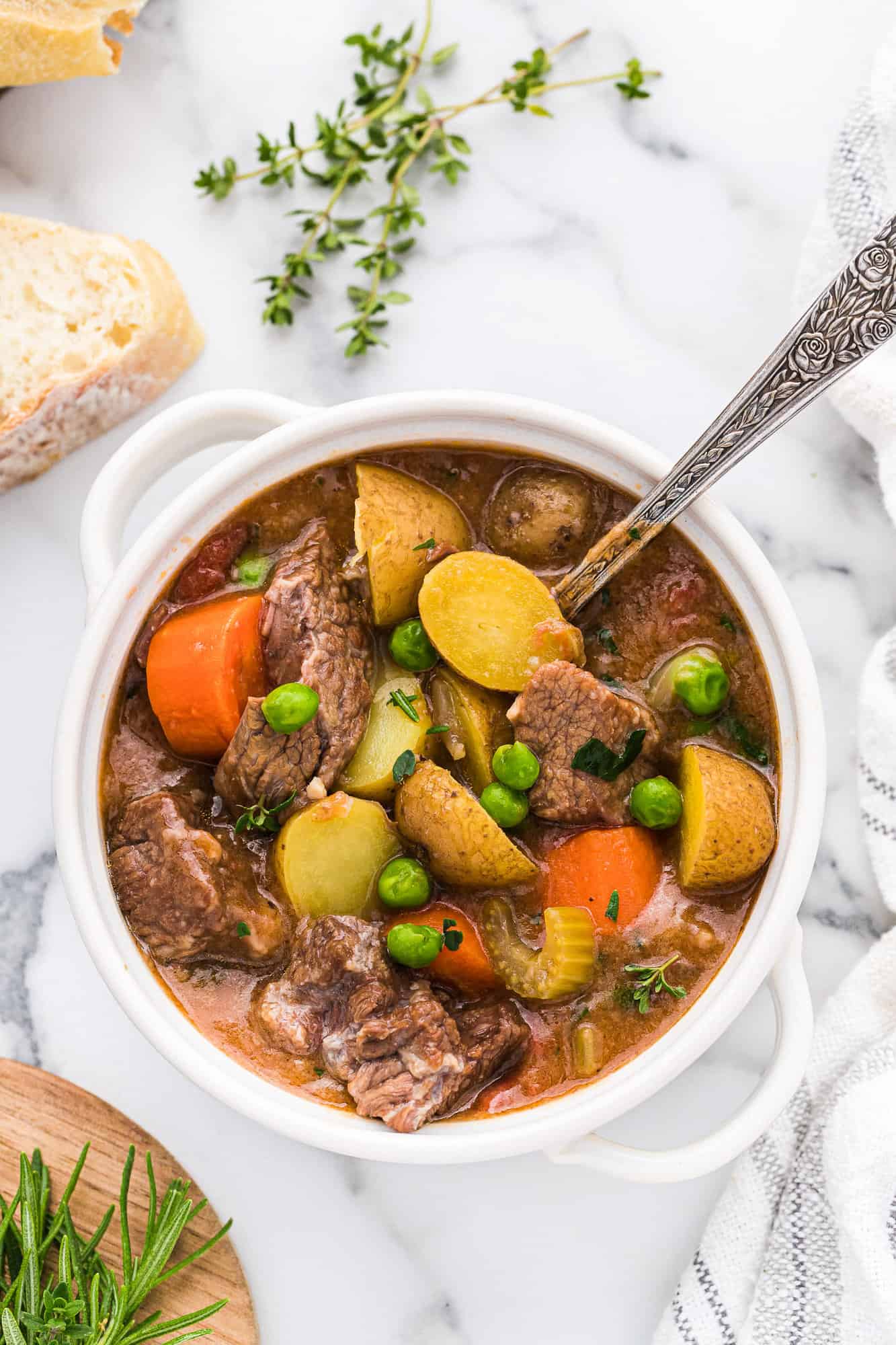 Crockpot beef stew in a white bowl.