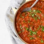 Homemade spaghetti sauce in a large yellow pot.