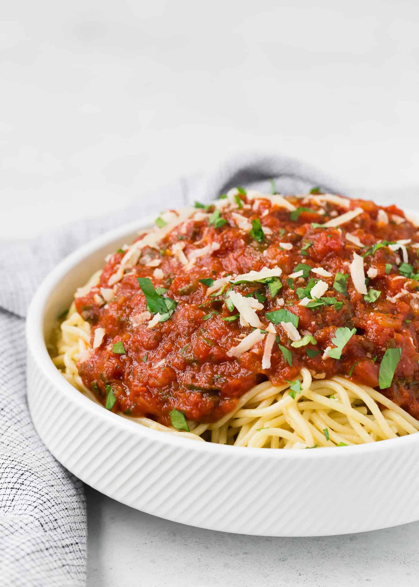 Spaghetti with spaghetti sauce and cheese.
