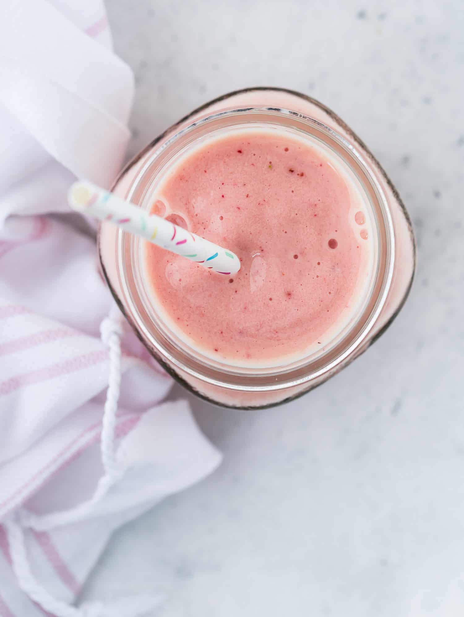 Overhead view of light pink smoothie.