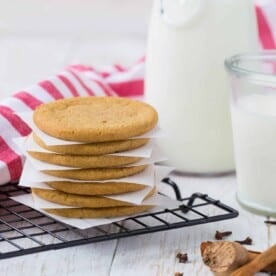 Windmill cookies stacked up with parchment between each one.