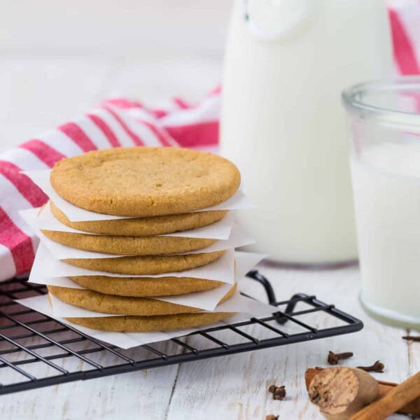 Windmill cookies stacked up with parchment between each one.