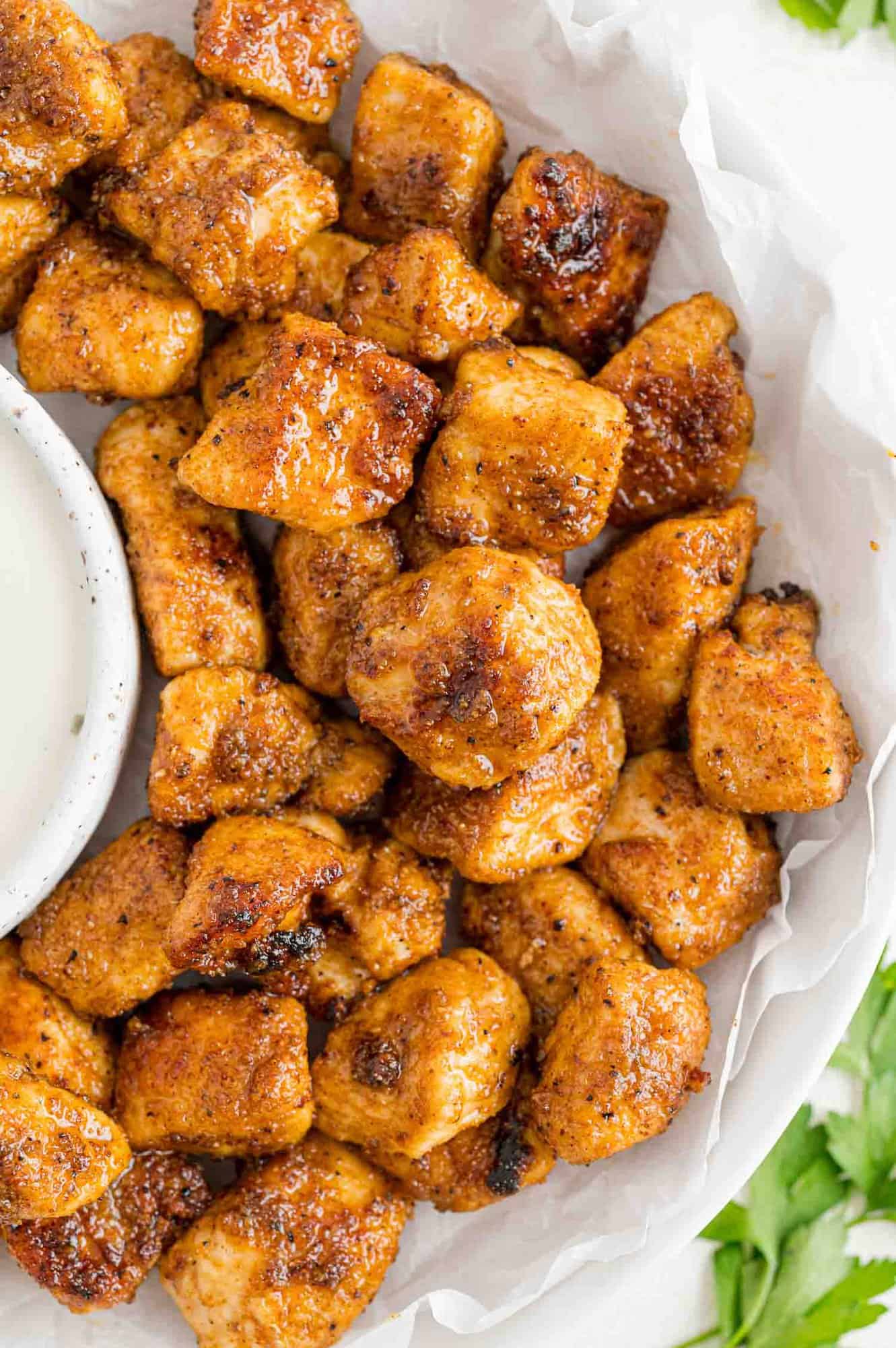 Chicken bites on a plate with ranch dressing.