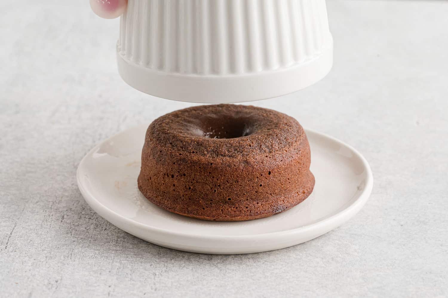 Lava cake coming out of ramekin.