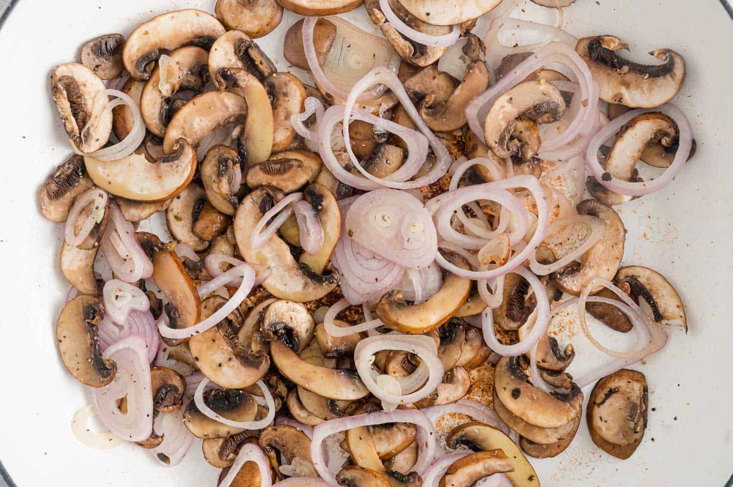 Mushrooms and shallots in pan.