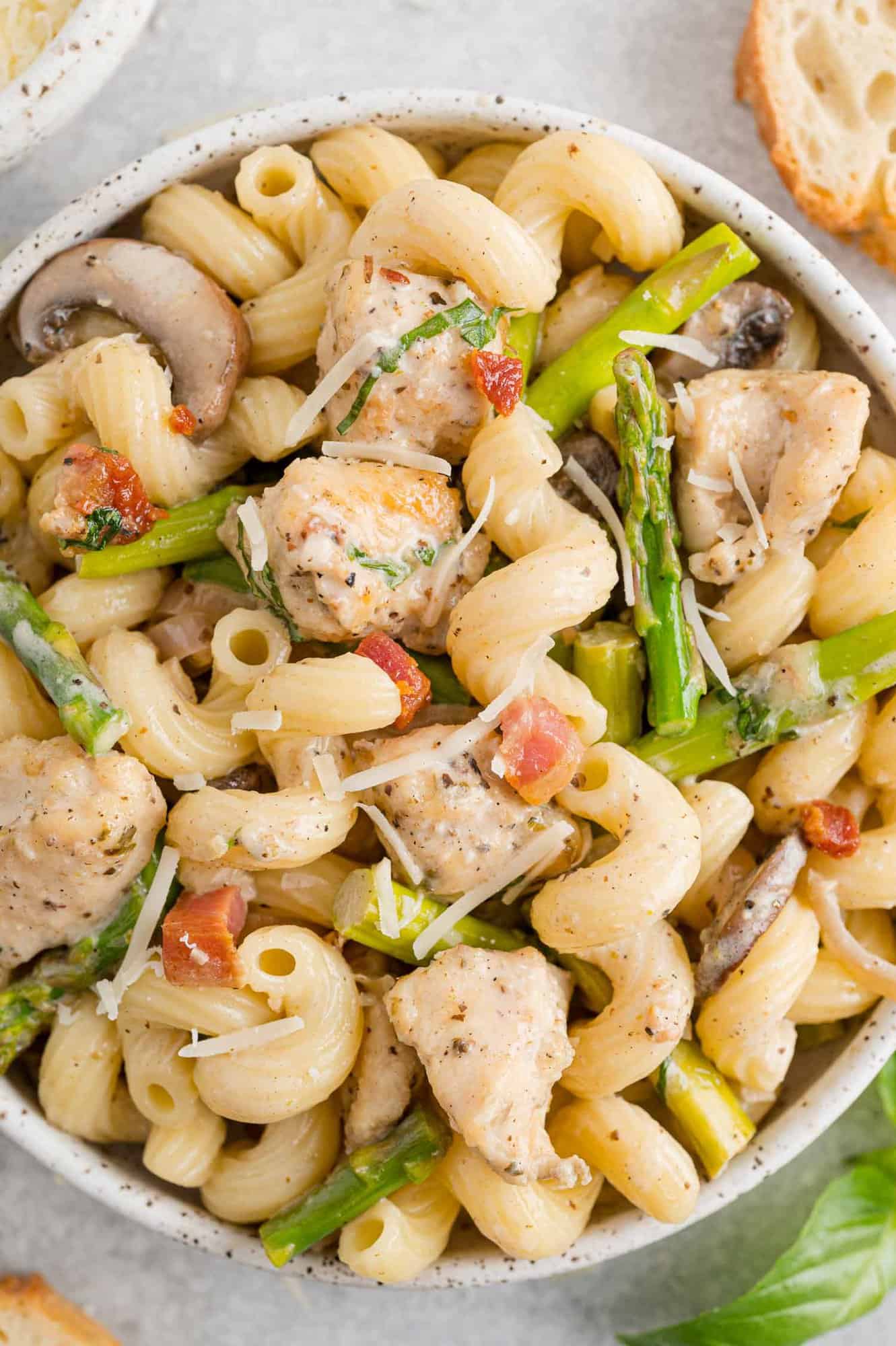 Pasta and asparagus with chicken in a bowl.