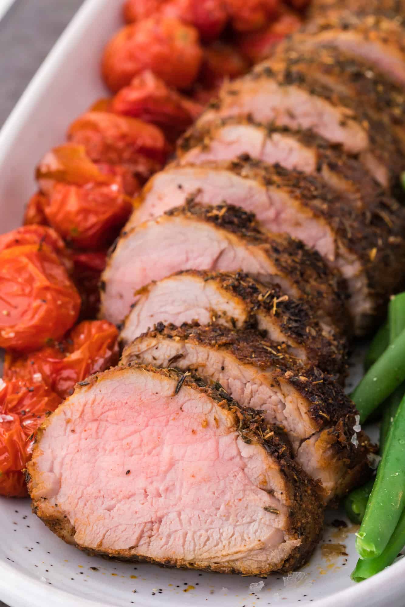 Spiced rubbed pork tenderloin, sliced and plated.