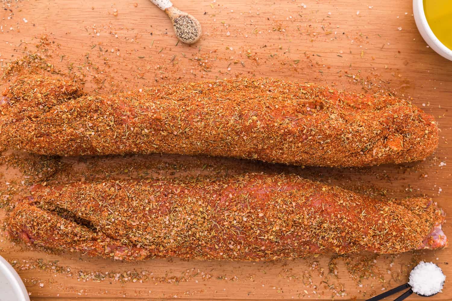 Uncooked tenderloins, rubbed with spices.