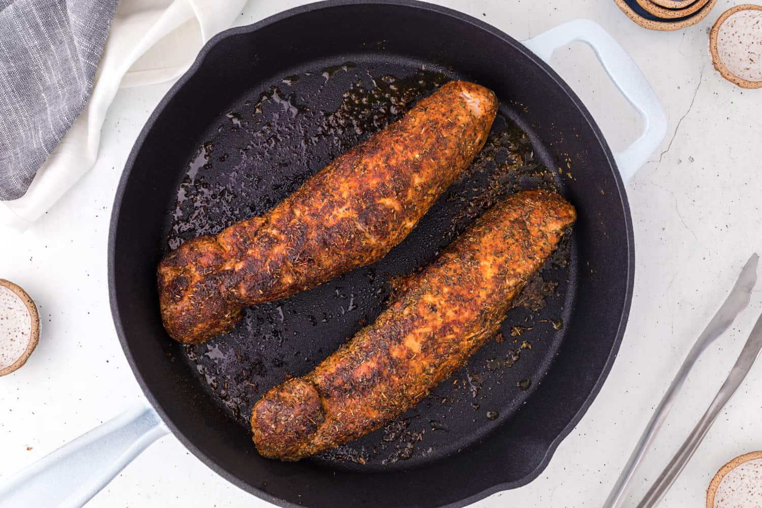 Pork tenderloins in cast iron skillet.