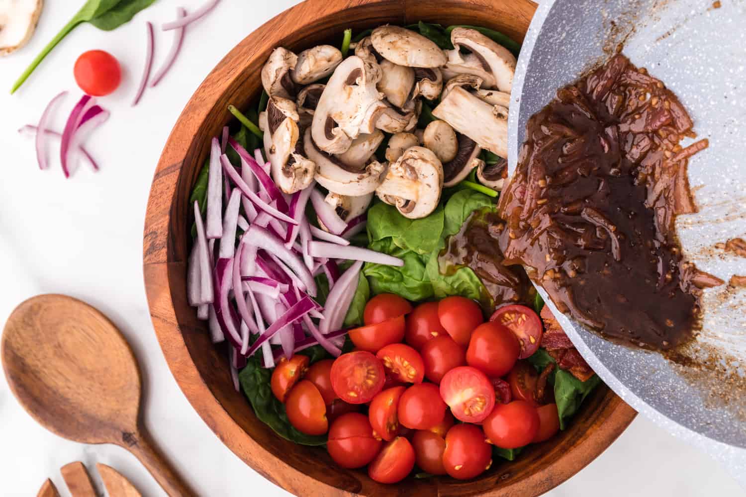 Dressing being poured on salad.