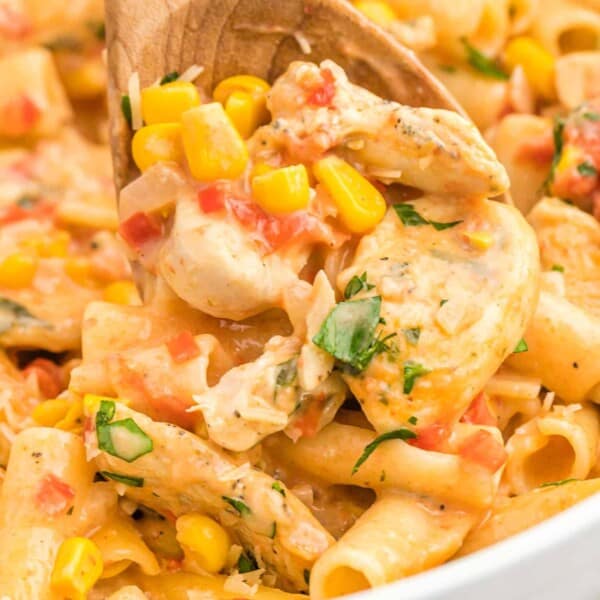 Cajun chicken pasta with a wooden spoon.