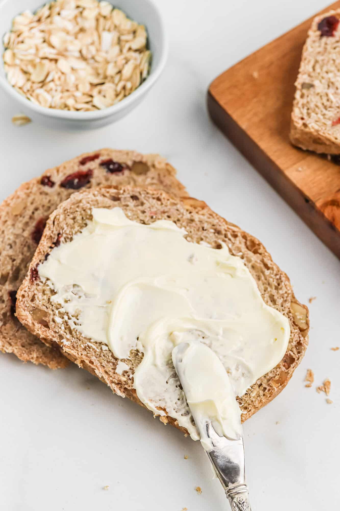 Butter being spread on bread.