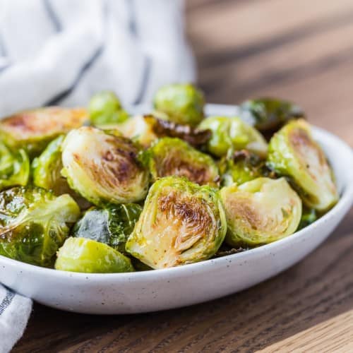 Maple cayenne roasted Brussels sprouts in small bowl.
