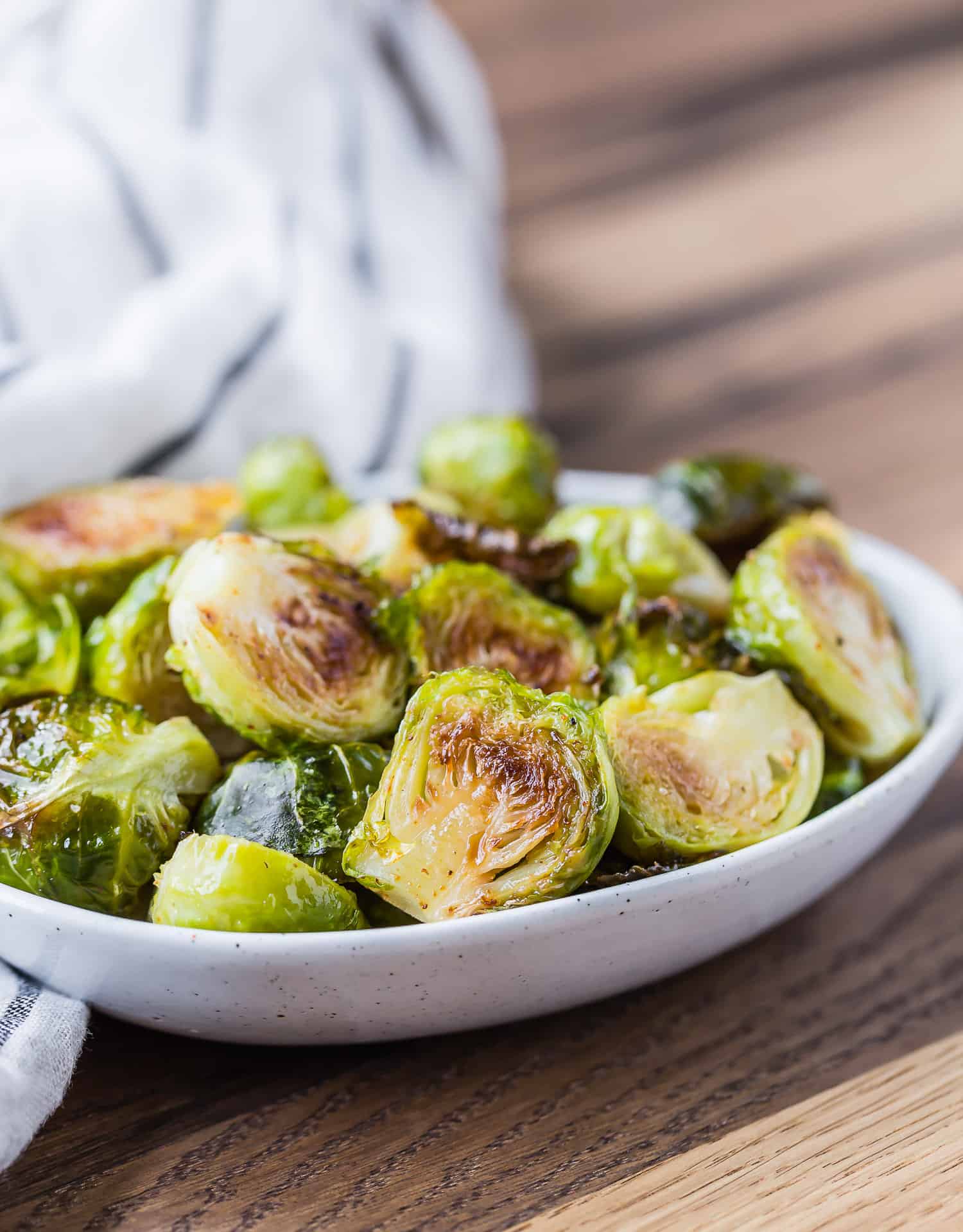 Maple cayenne roasted Brussels sprouts in small bowl.