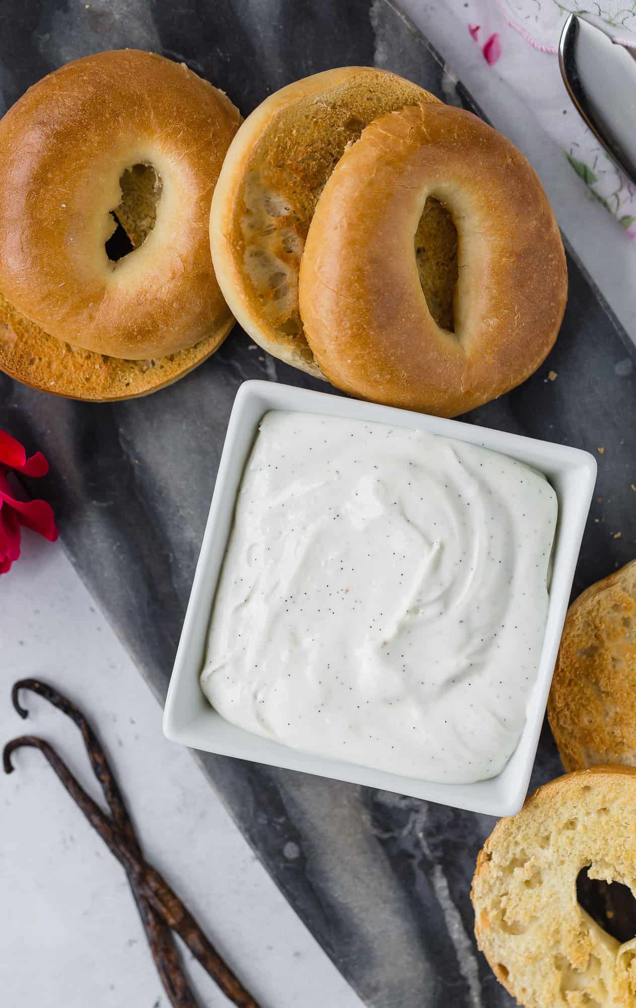 Cream cheese with vanilla beans, surrounded by bagels.
