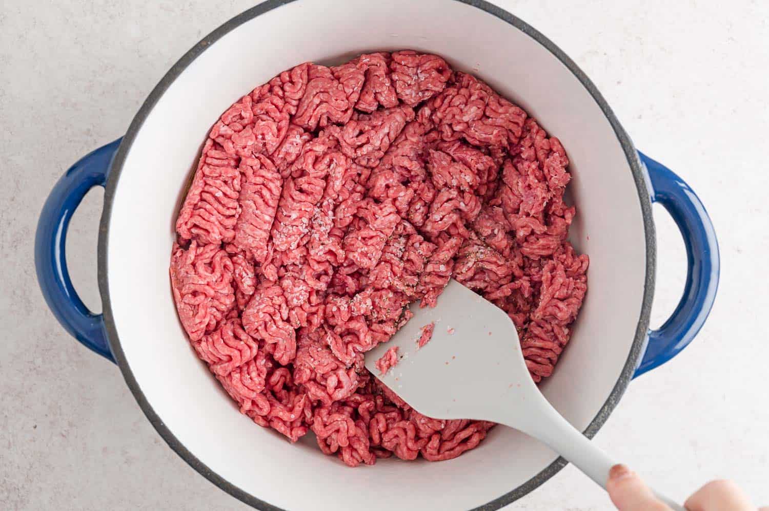 Beef being browned in a pan.