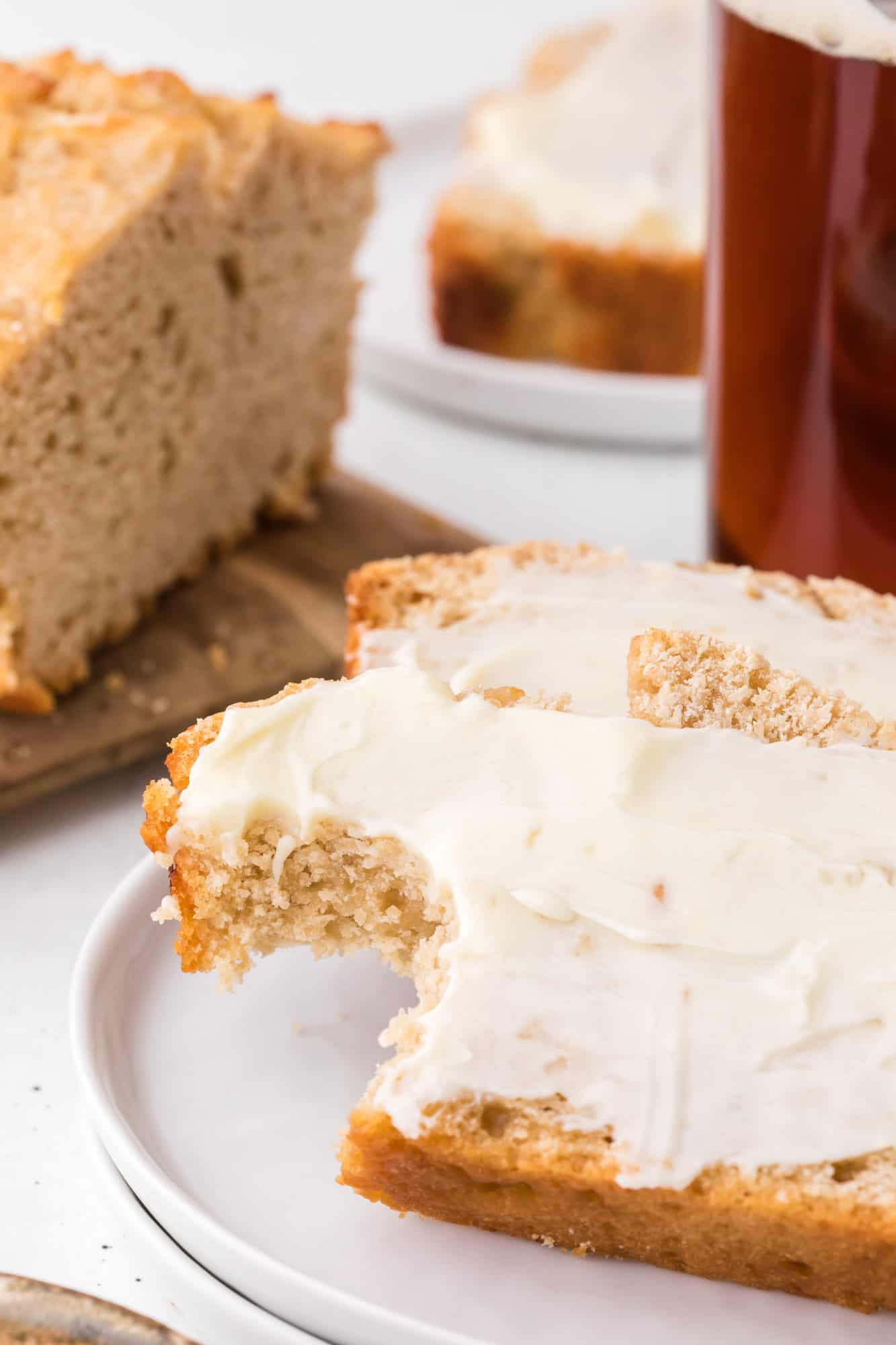 Beer bread with butter and a bite taken out.