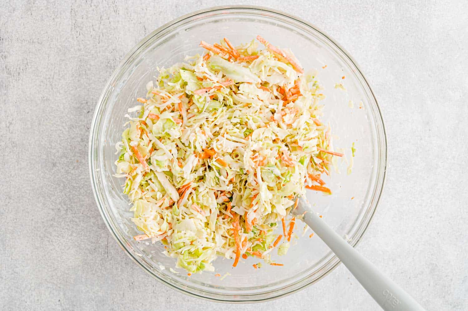 Coleslaw being mixed up.