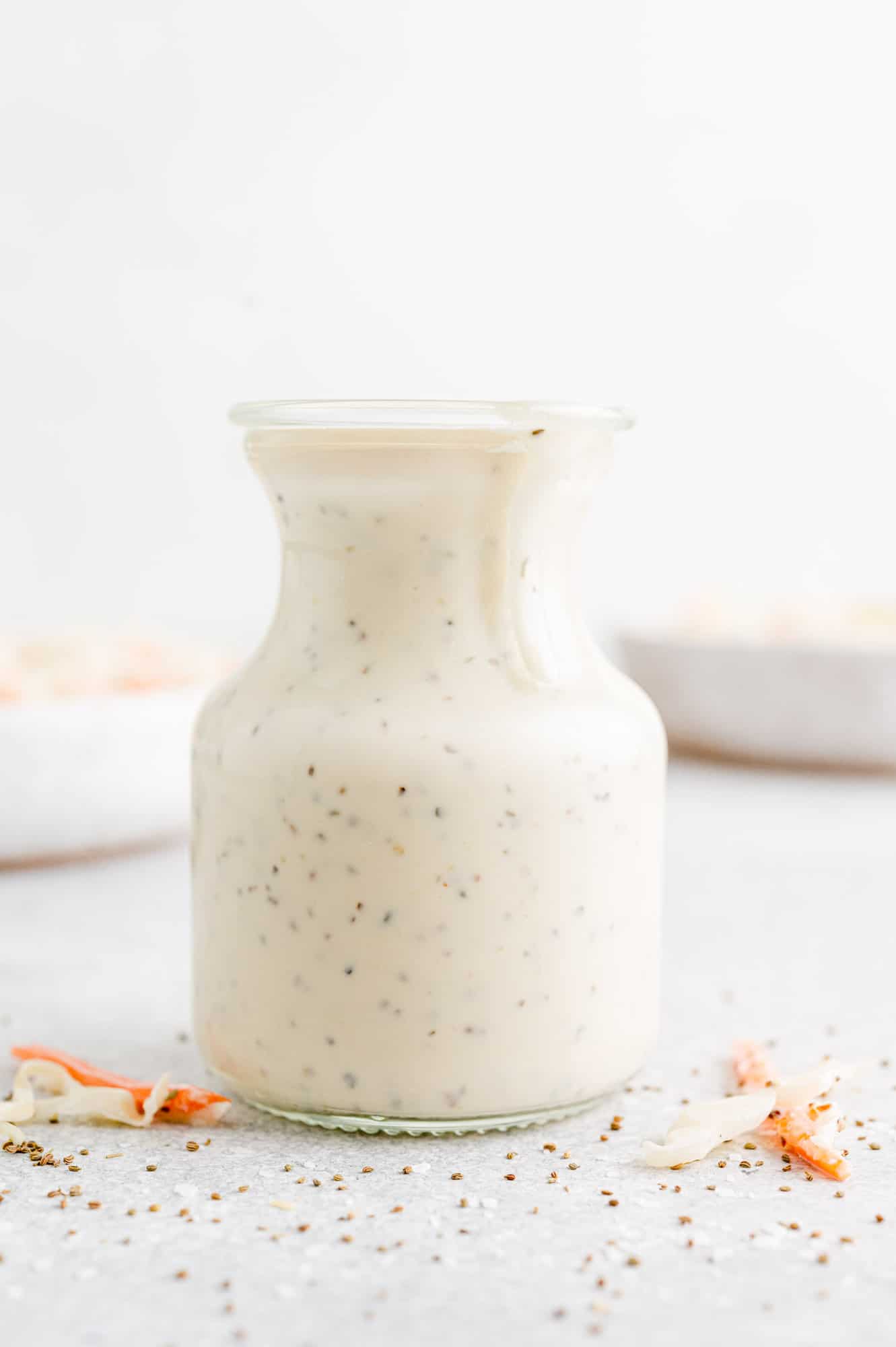 Coleslaw dressing in a small jar.