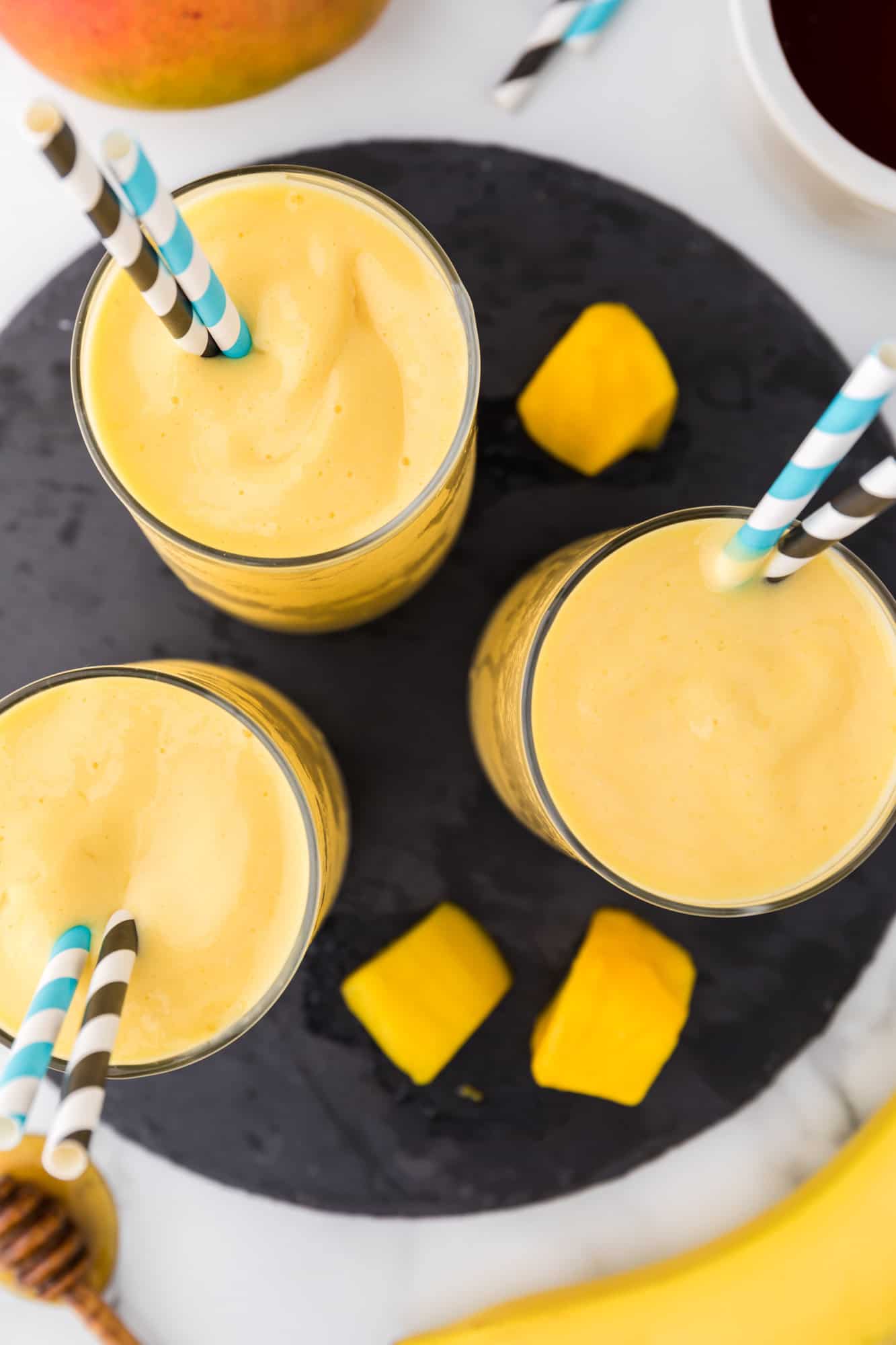 Overhead view of mango smoothies.