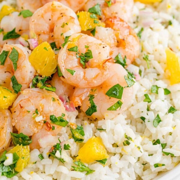 Shrimp with chimichurri rice and oranges.