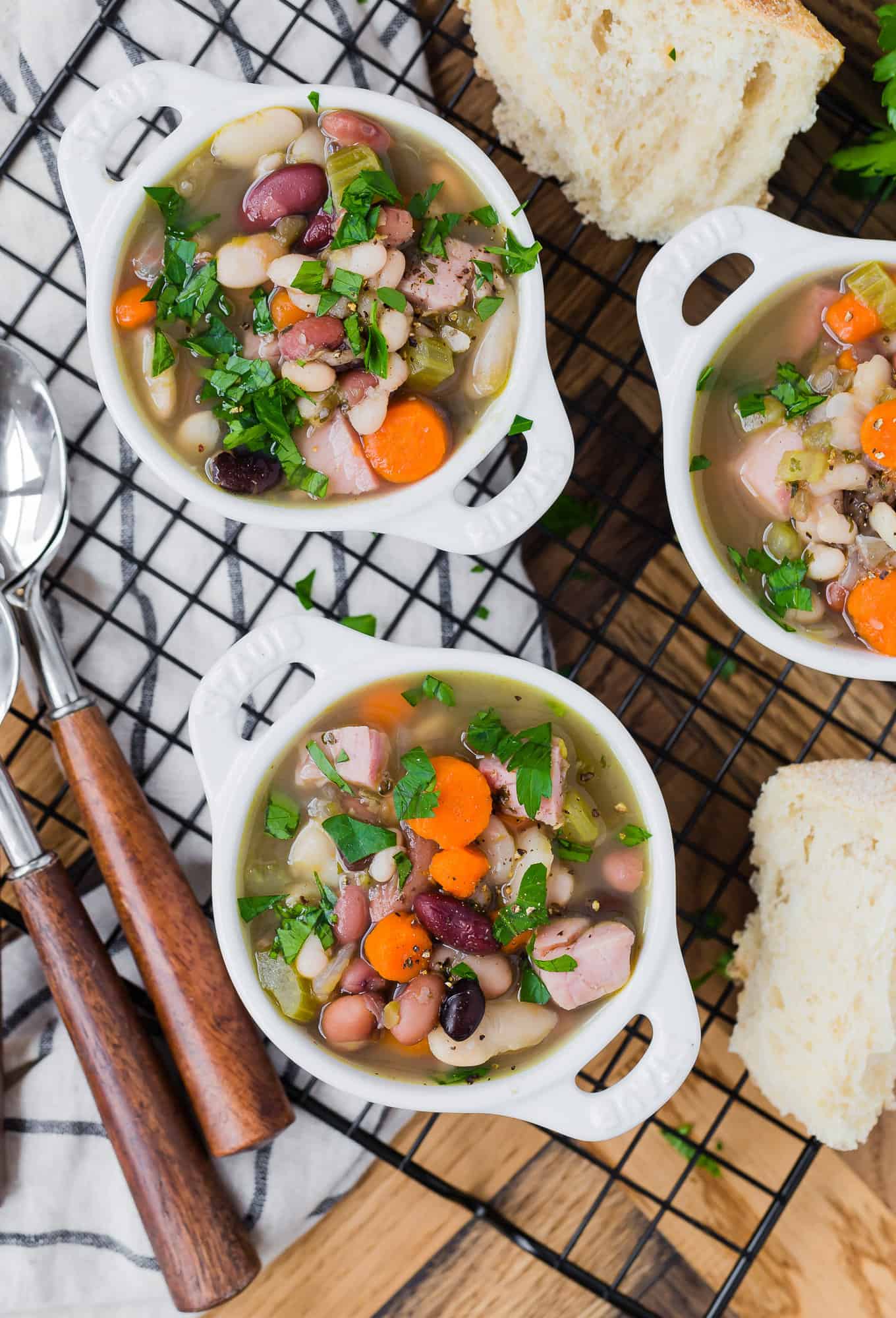 Three bowls of bean soup with ham.