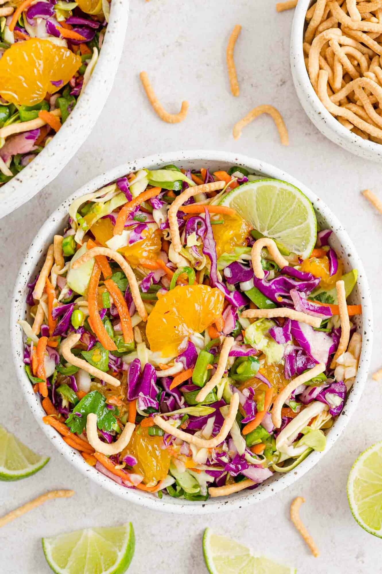 Colorful salad with chow mein noodles as a garnish.