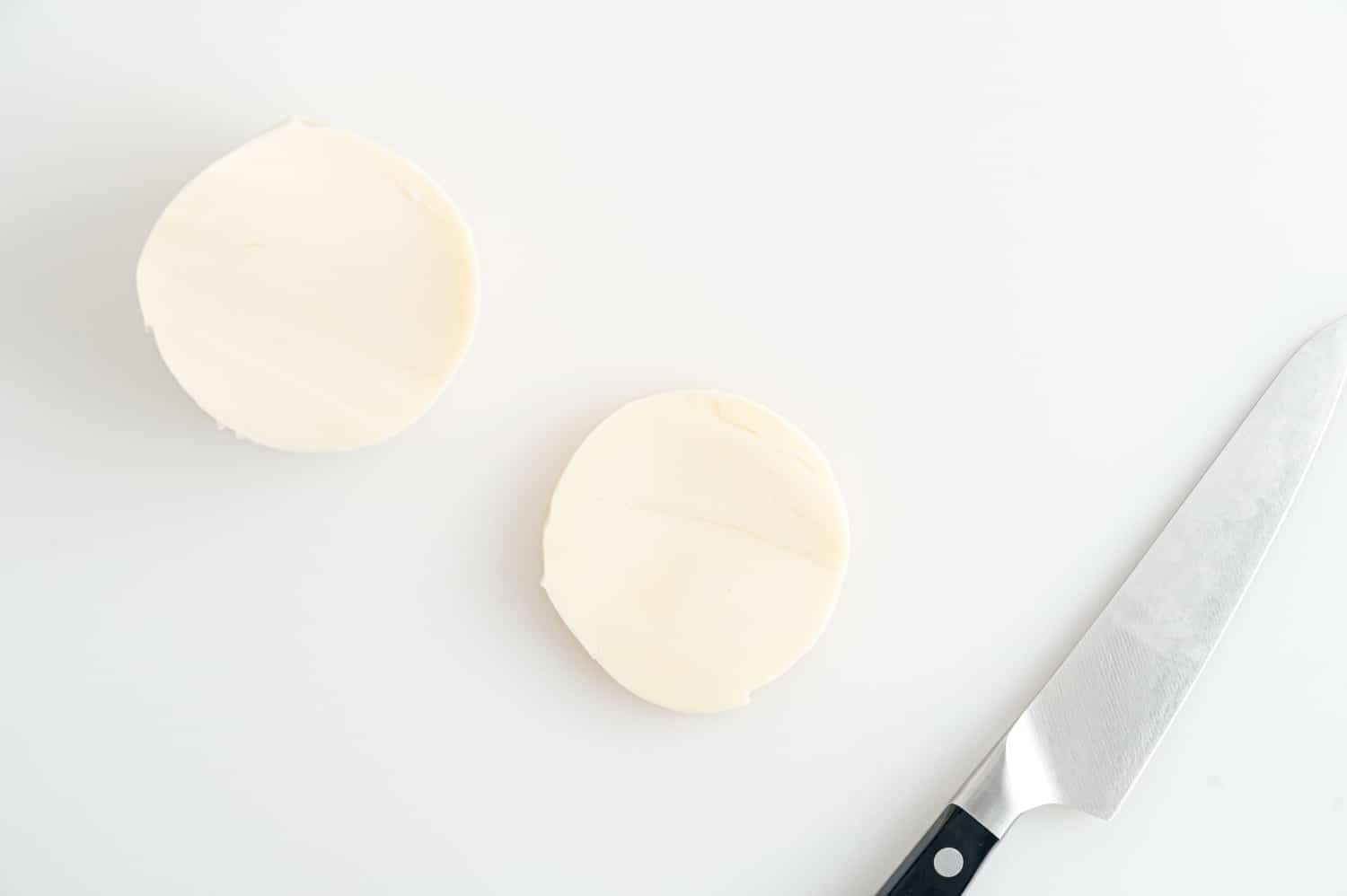 Fresh mozzarella being sliced.