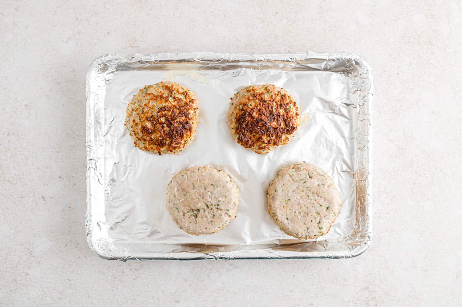 Half of turkey burgers broiled.