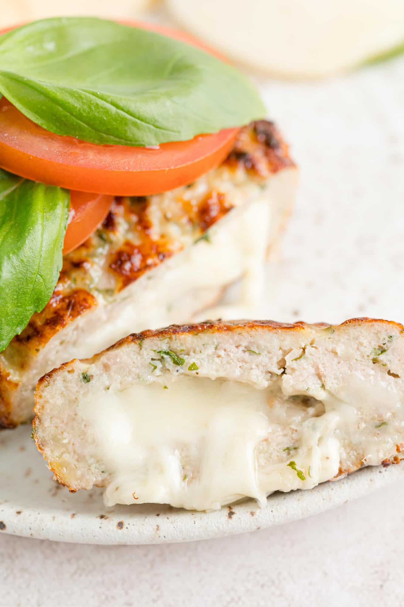 Turkey burger cut to show mozzarella filling.