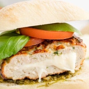 Caprese turkey burger cut to show mozzarella filling.