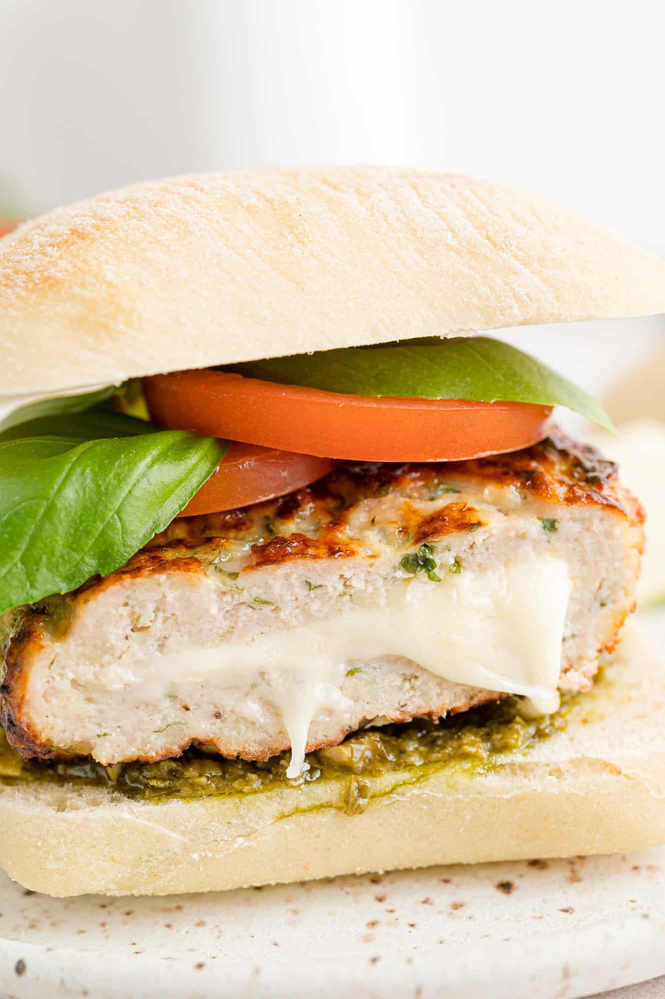 Caprese turkey burger cut to show mozzarella filling.