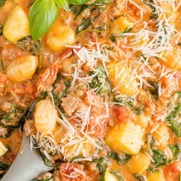 Creamy one pan gnocchi with spinach, sprinkled with cheese.
