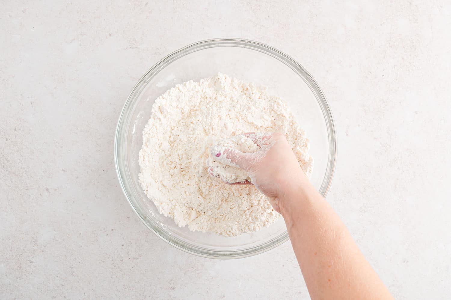 Butter being mixed with flour.