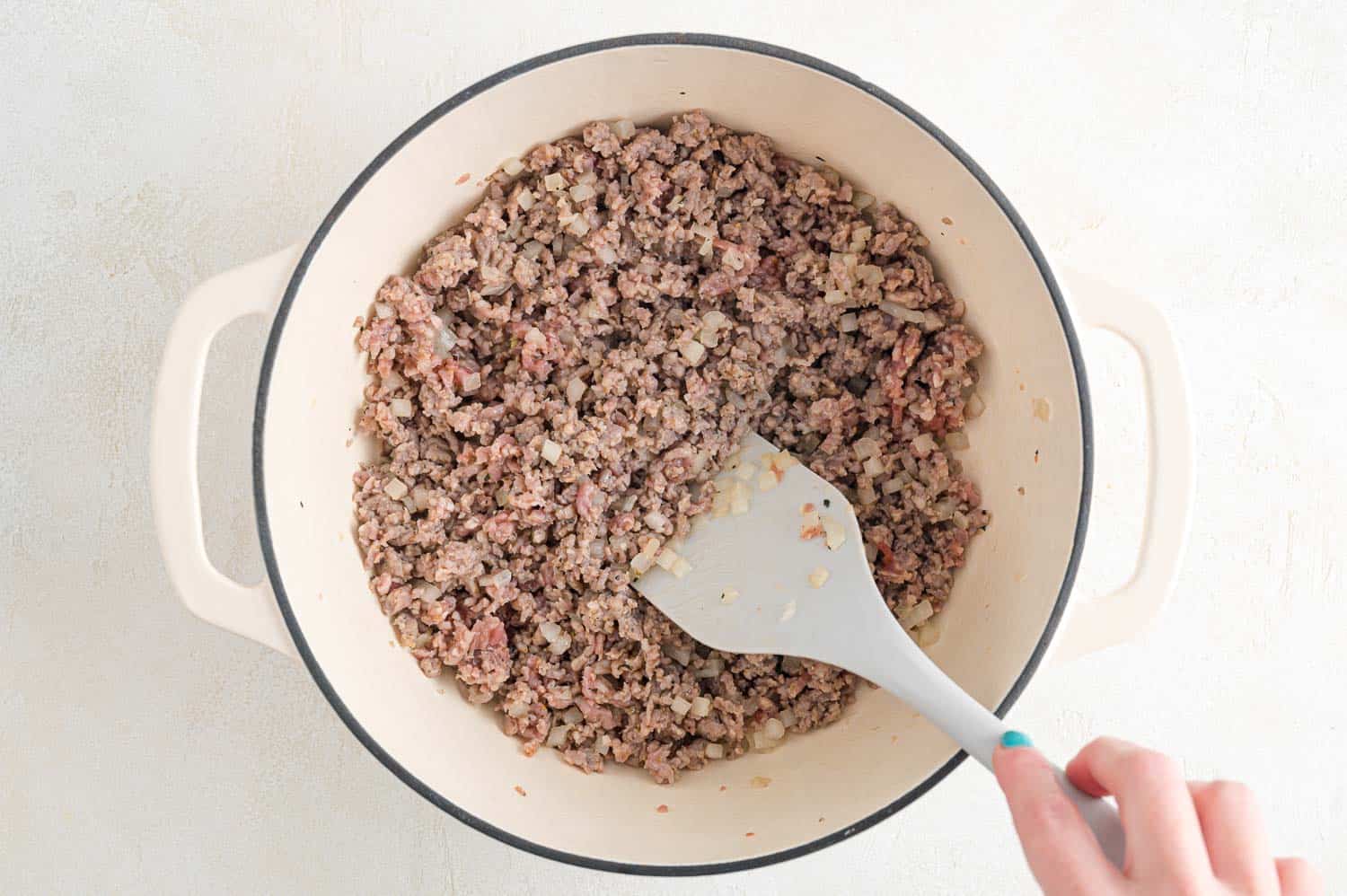 Sausage and onions being browned.