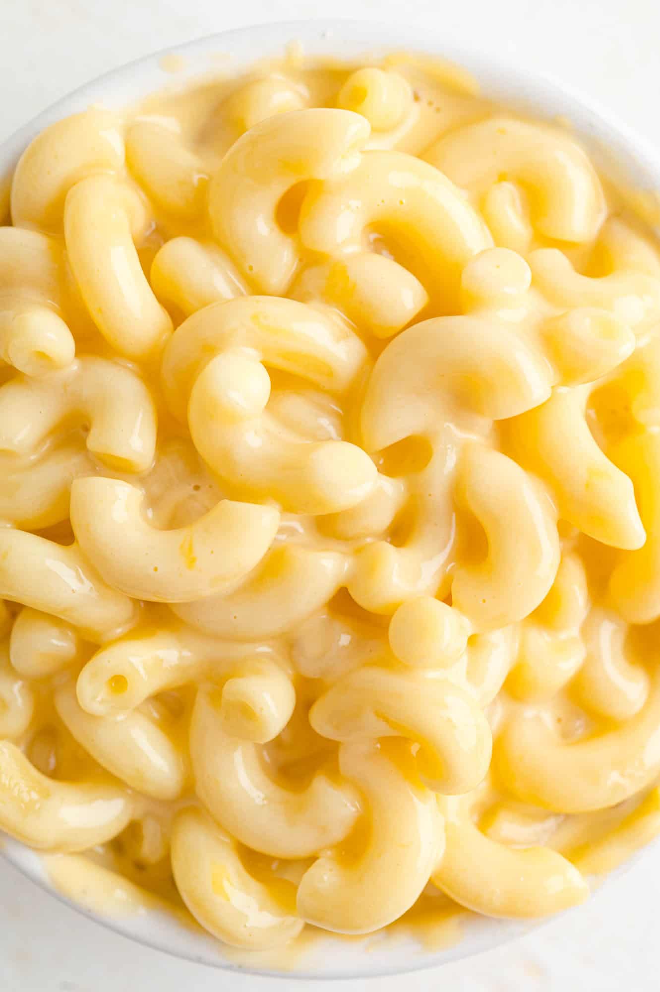 Close up of macaroni and cheese in a white bowl.