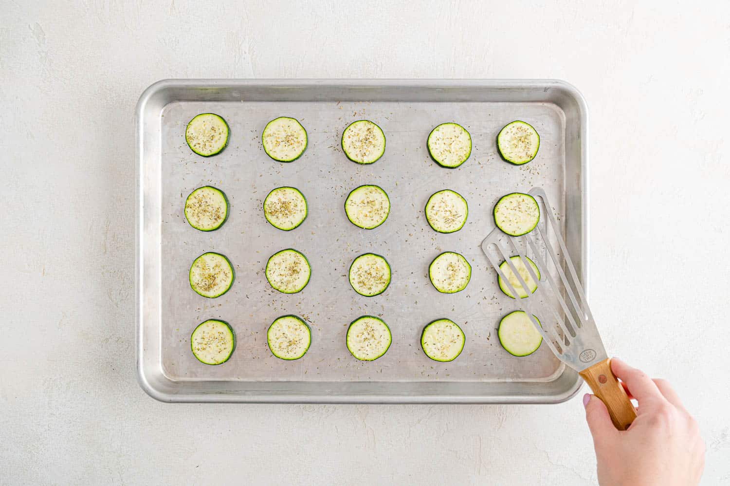 Zucchini slices being flipped.