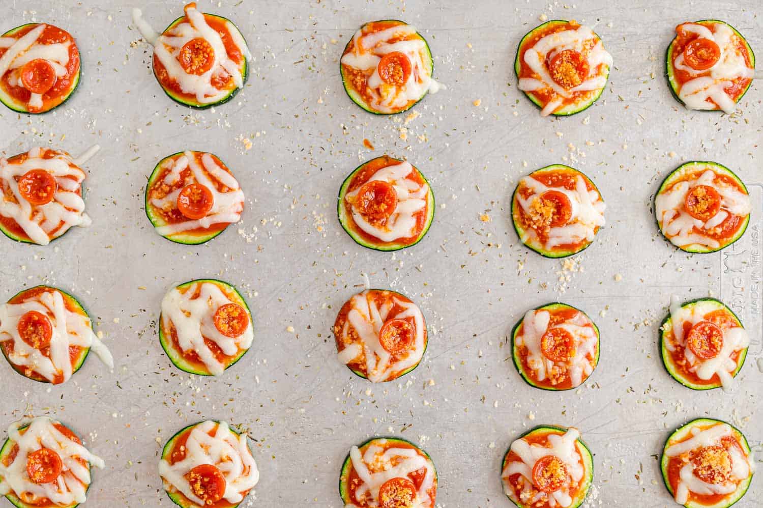 Zucchini pizza slices on a sheet pan.