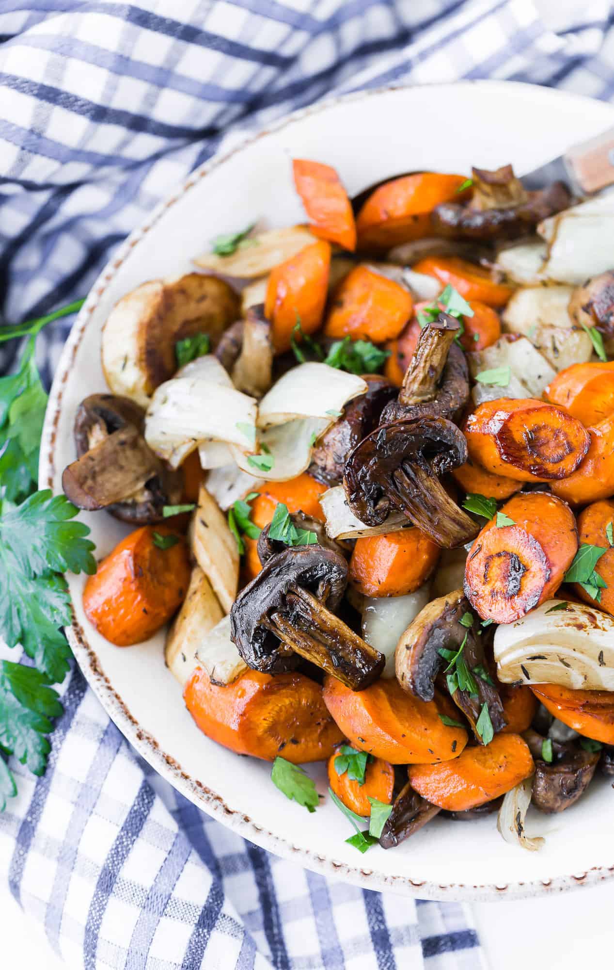 Balsamic roasted vegetables in a bowl, garnished with parsley.