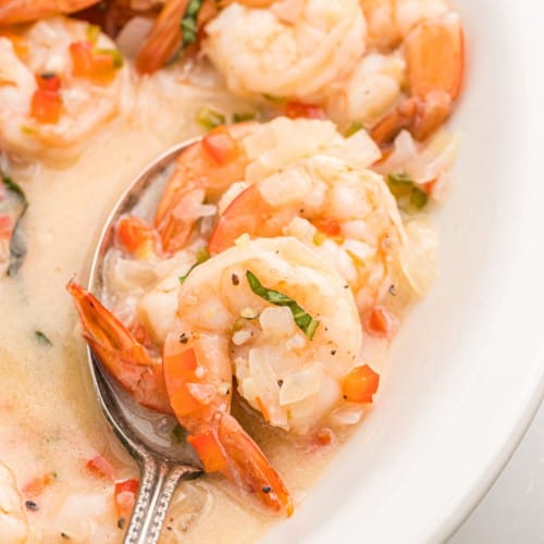 Creamy coconut shrimp on a serving spoon.