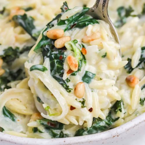 Creamy lemon orzo with greens, topped with pine nuts.
