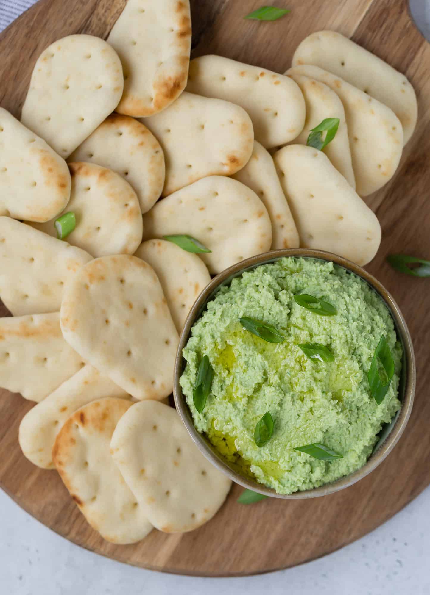 Overhead view of dipped served with mini pitas.