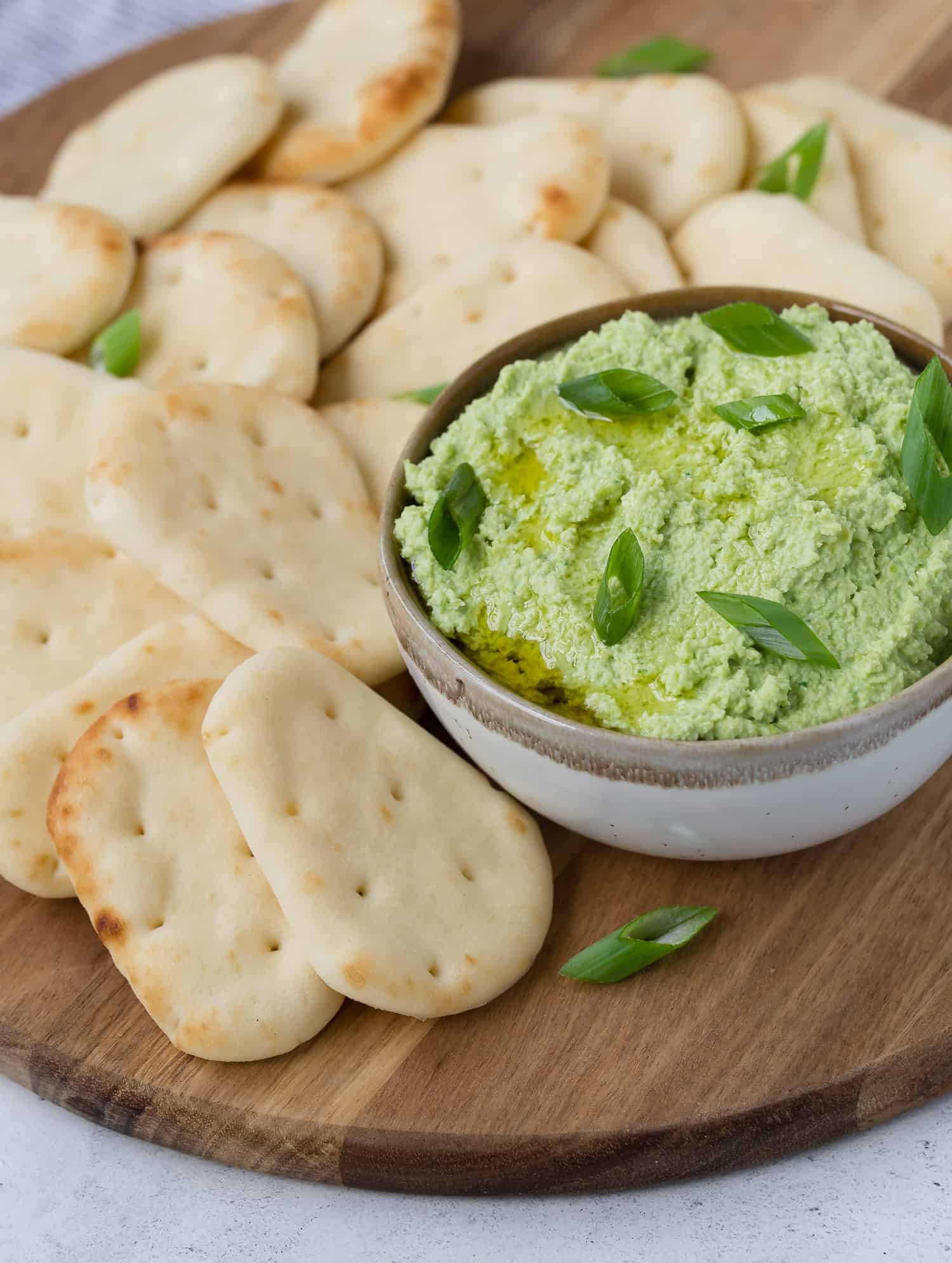 Edamame dip topped with green onions.