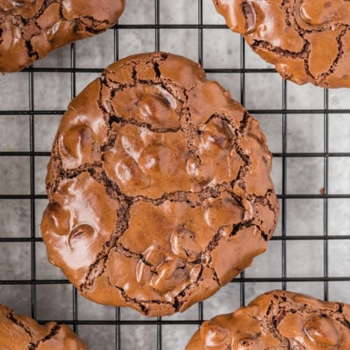 Flourless chocolate cookie on a cooling rack.