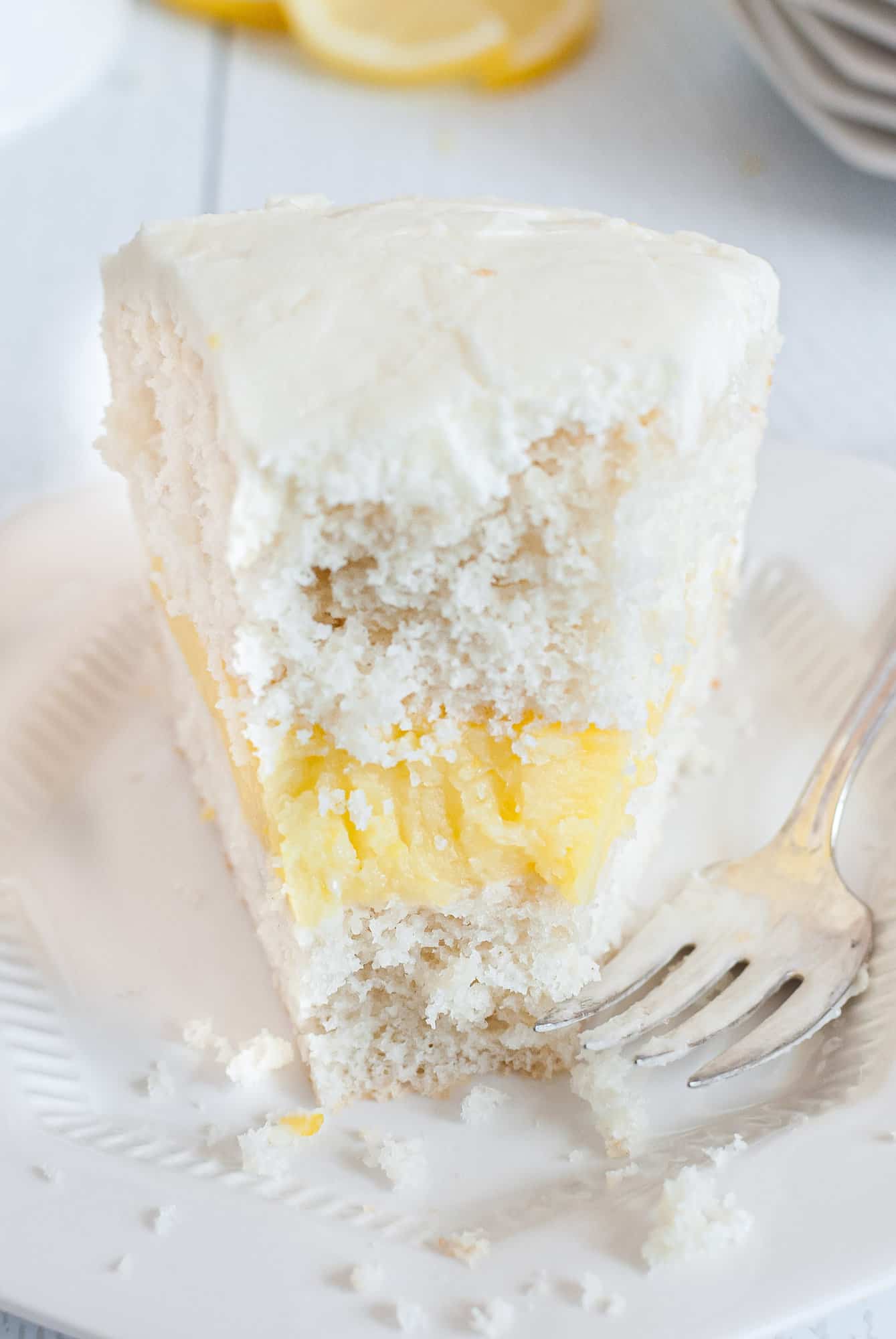 Cake with lemon filling, bite removed.