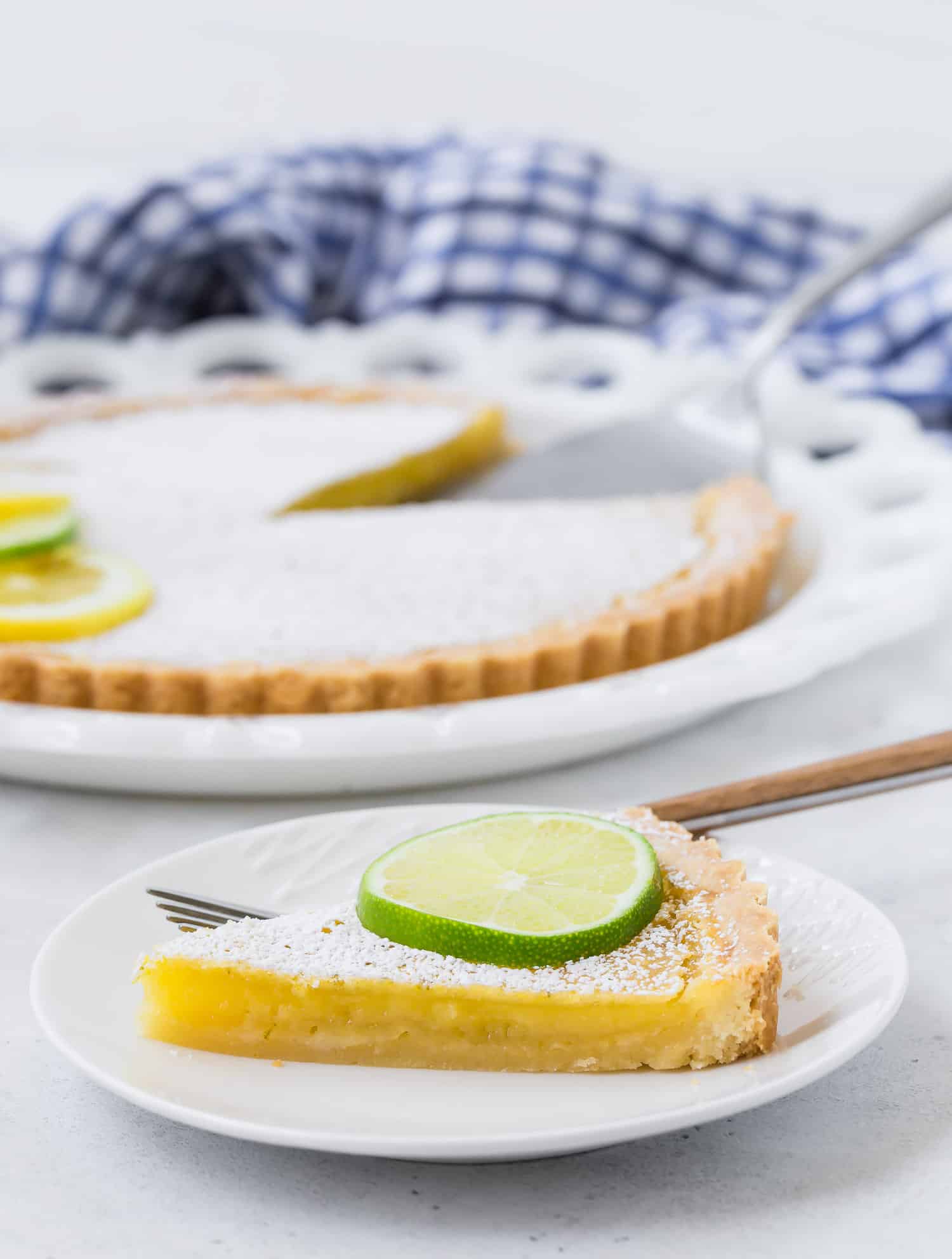 Slice of lemon lime tart, showing filling.