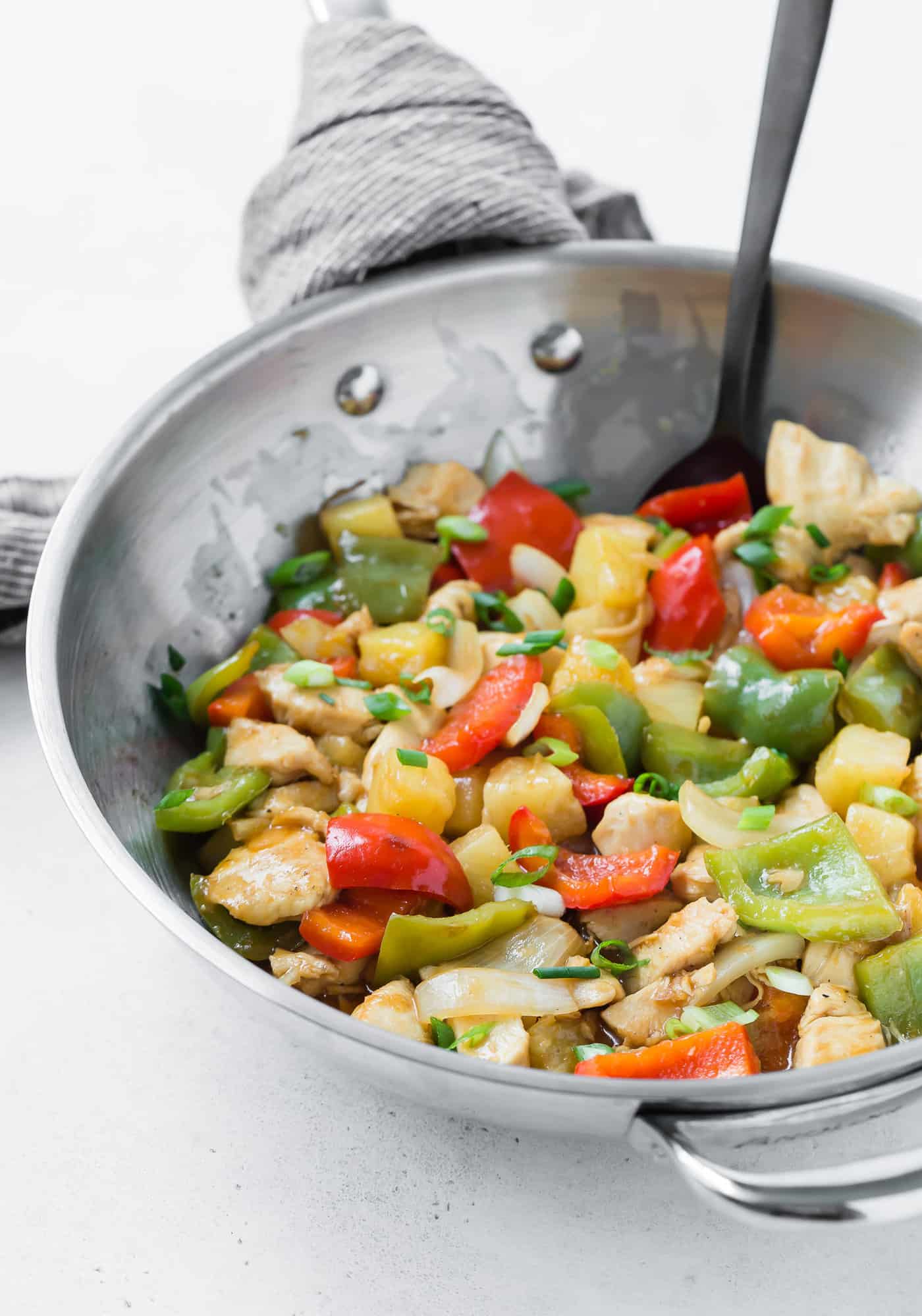 Chicken stir fry with sweet and sour sauce and vegetables.