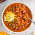 Beef chili with beans in a white bowl.