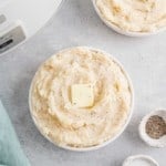 Crockpot mashed potatoes in a white bowl.