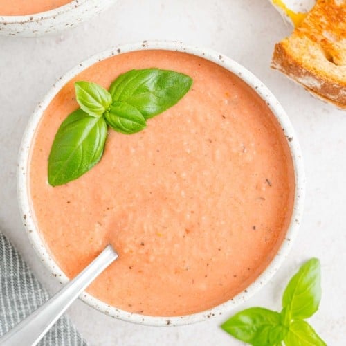 Creamy tomato soup topped with basil.